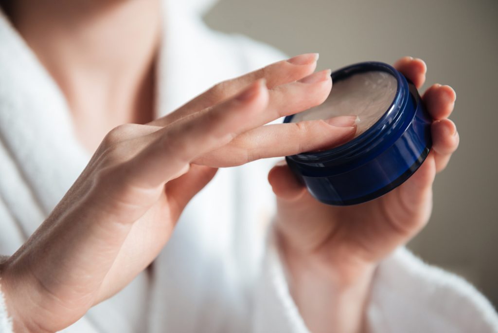 close up young woman hands holding jar cream scaled 1